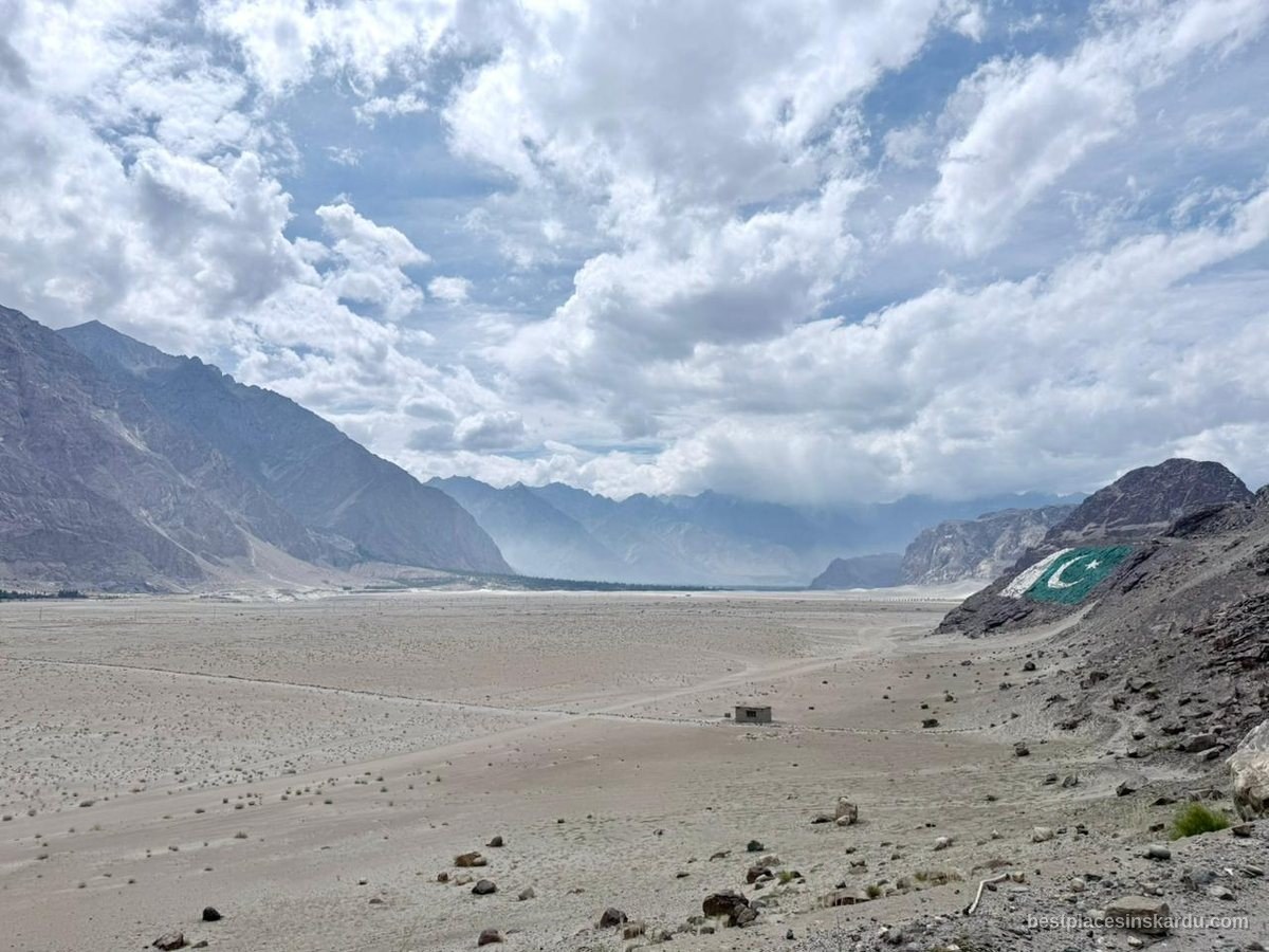 Sarfaranga cold desert with a Pakistan flag painted on the hillside near Skardu