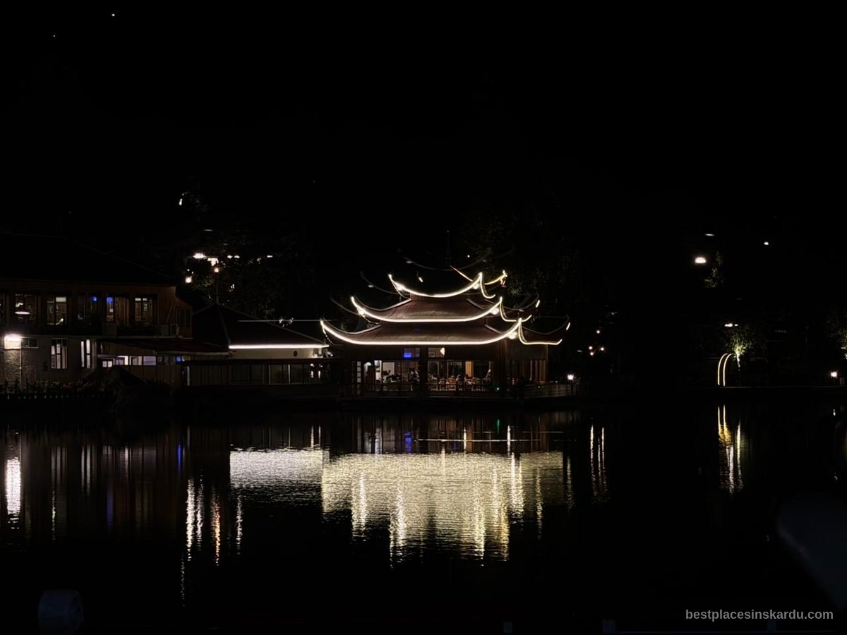 Shangrila Resort restaurant lit at night reflected in Lower Kachura Lake, Skardu