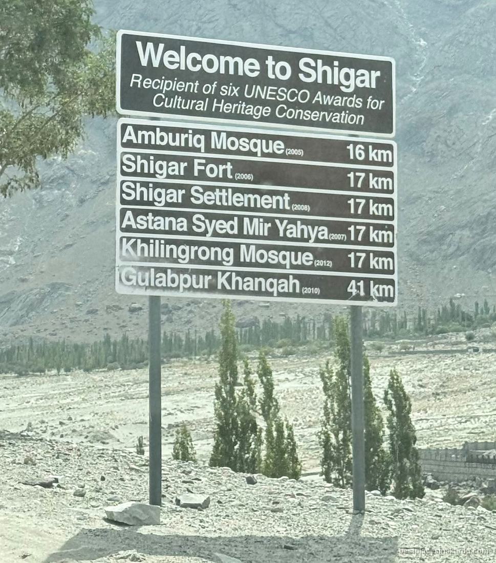 Signboard listing Shigar's six UNESCO Cultural Heritage Conservation awards and site distances