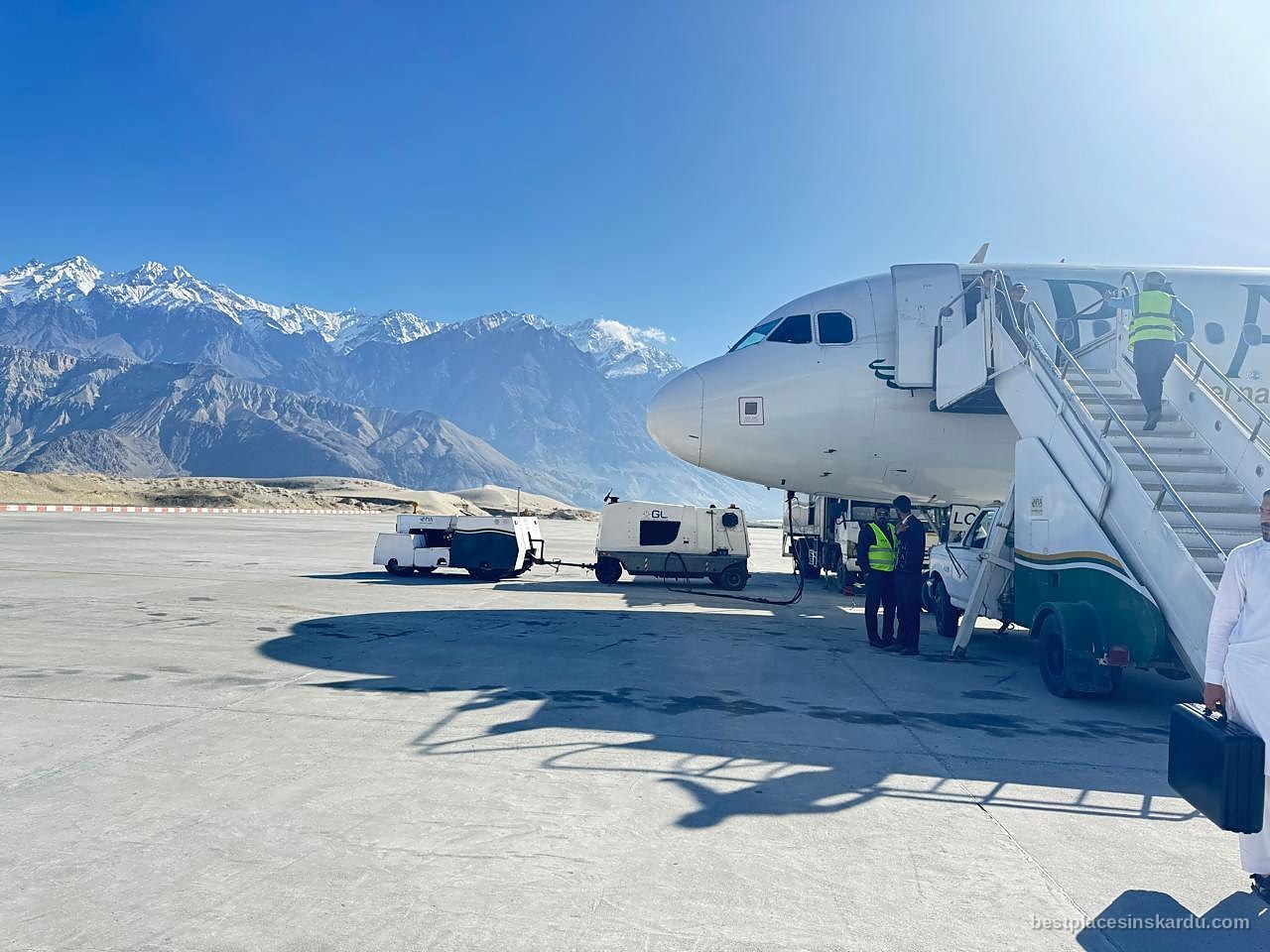 PIA aircraft on the apron at Skardu International Airport with Karakoram peaks behind