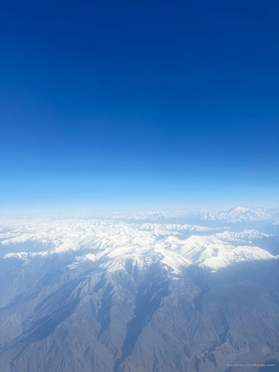 View from an aircraft window over the Karakoram on the Islamabad to Skardu route, wing visible
